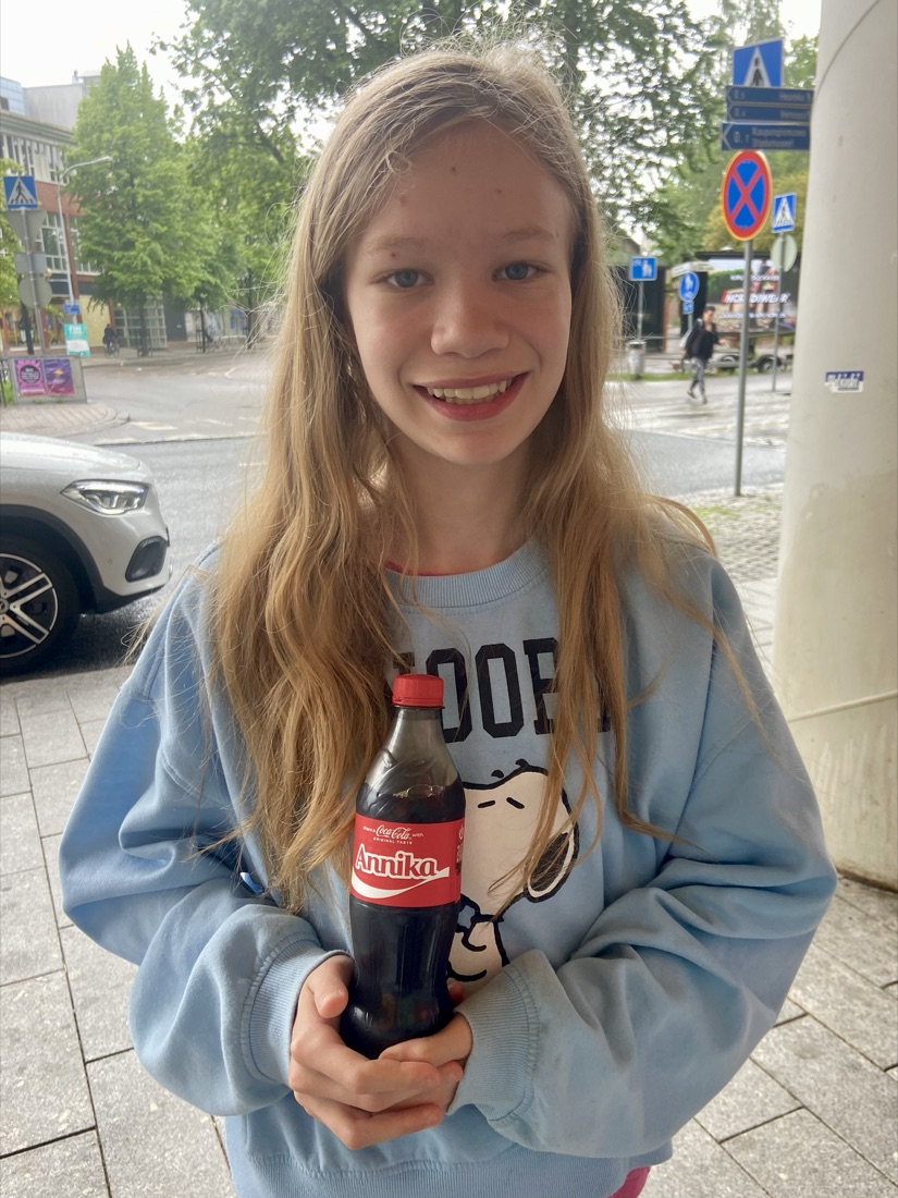 Annika holding a personalised Coca-Cola bottle with her name on it